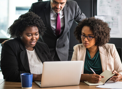 three people working together on laptop